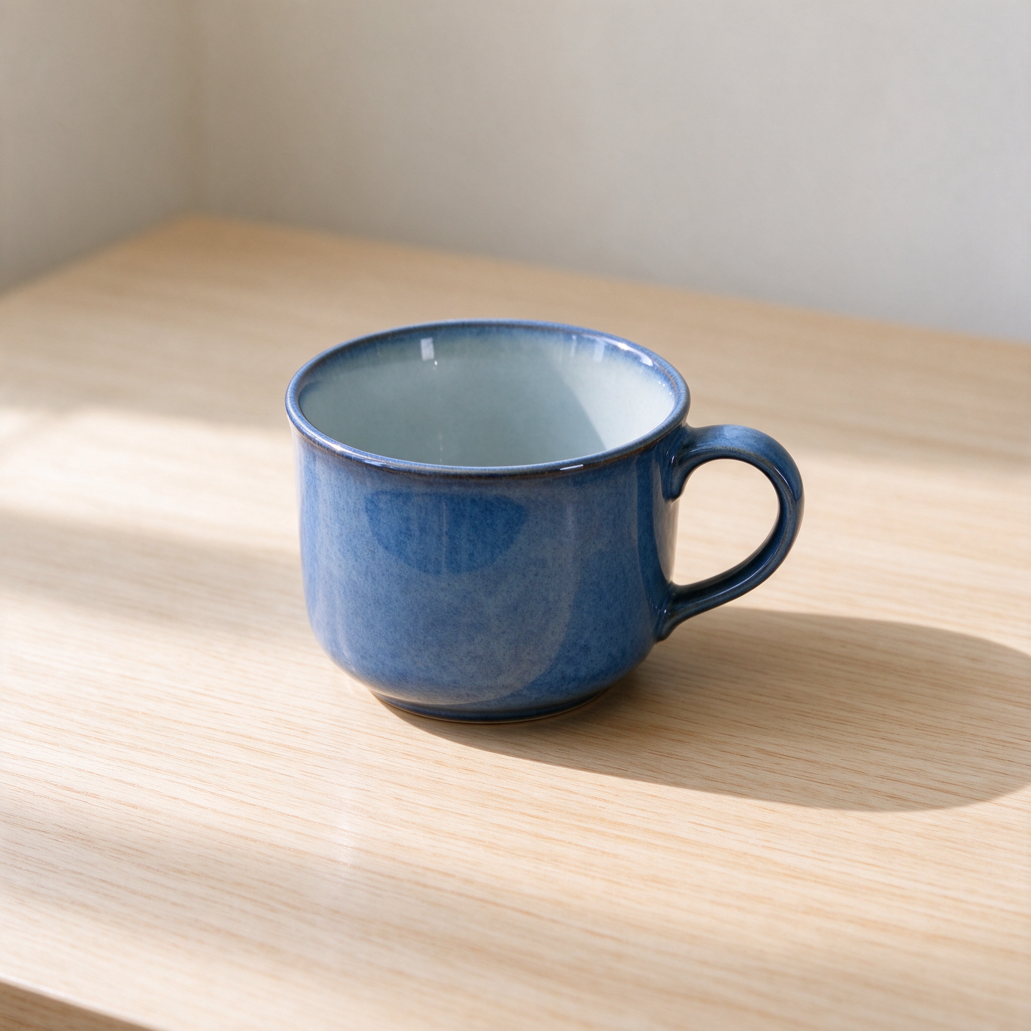 Seedream 5.0 Flash sample: A blue ceramic cup on a pale wooden desk, soft natural daylight, no text.