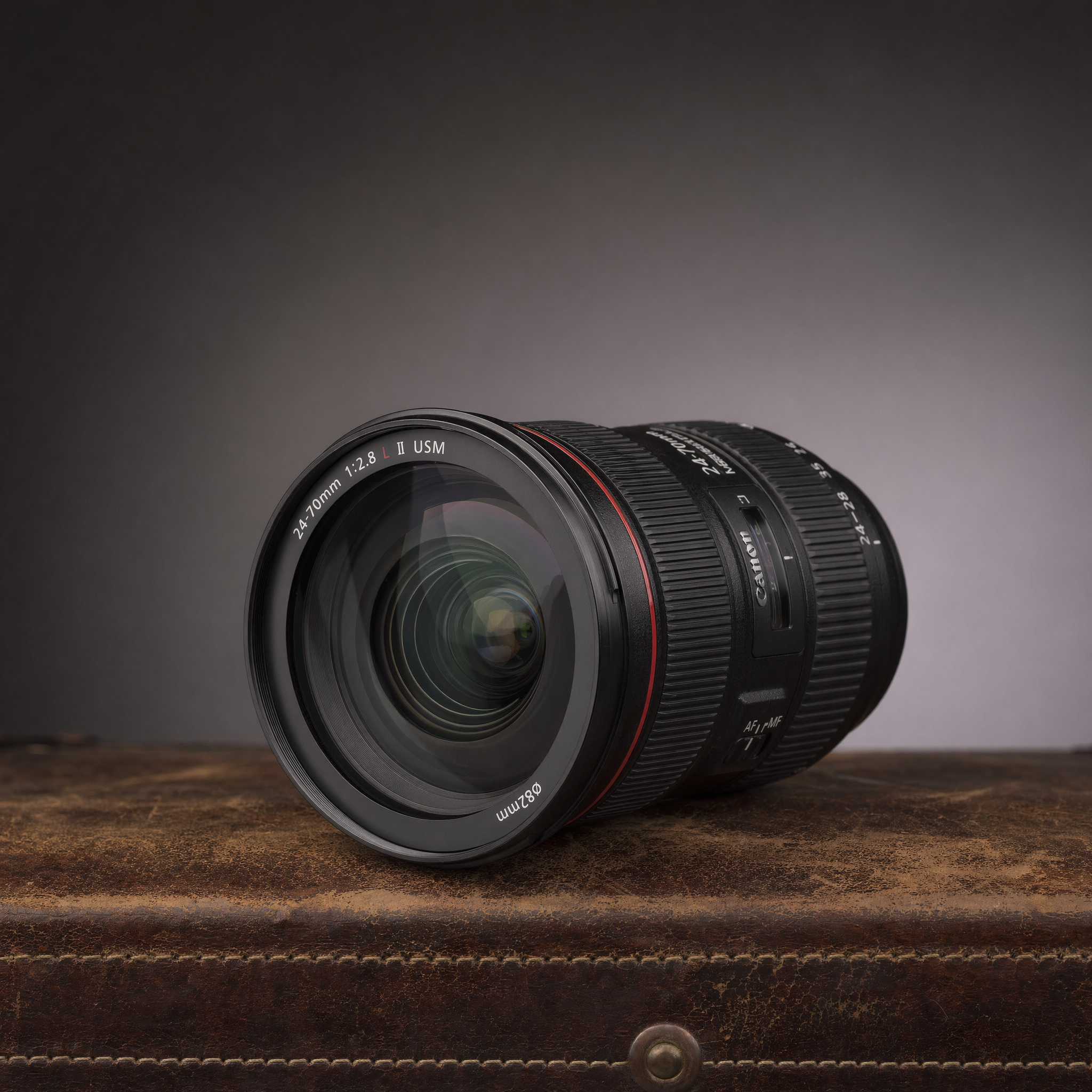 A high-end camera lens on a weathered leather surface with soft gradient background, professional studio shot